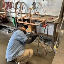 Plumber brazing a copper manifold during a whole home repipe in Boynton Beach FL