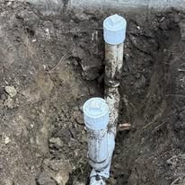 New sewer line pipe installation in an open trench at a Boynton Beach property