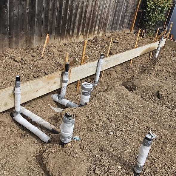 Under slab sewer and drain rough-in staked out before a concrete pour in Boynton Beach